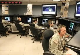 Space operations center with personnel at workstations